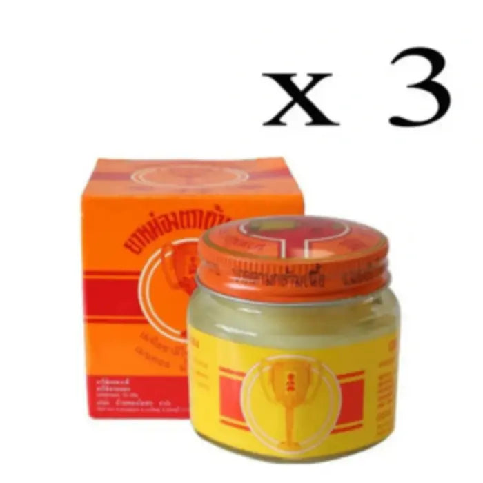 Pot et boîte de baume White Monkey Holding Peach avec étiquette représentant un singe tenant une pêche. Texte en thaï et en anglais. Utilisé pour soulager les douleurs musculaires. Mention fois 3.