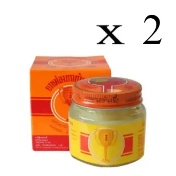 Pot et boîte de baume White Monkey Holding Peach avec étiquette représentant un singe tenant une pêche. Texte en thaï et en anglais. Utilisé pour soulager les douleurs musculaires. Mention fois 2