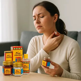 Femme appliquant du baume du tigre rouge sur son cou pour soulager une douleur musculaire. 