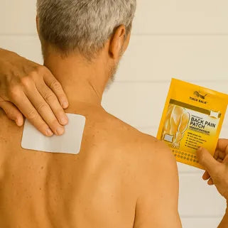 Hombre aplicando un parche para aliviar el dolor de espalda con envase amarillo visible.