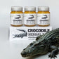 Trois pots de Crocodile Herbal Balm posés sur leur boîte, accompagnés d’un crocodile décoratif. Baume traditionnel conçu pour apaiser irritations, douleurs légères et inconforts cutanés. Packaging avec crocodile, évoquant un soin puissant et protecteur.