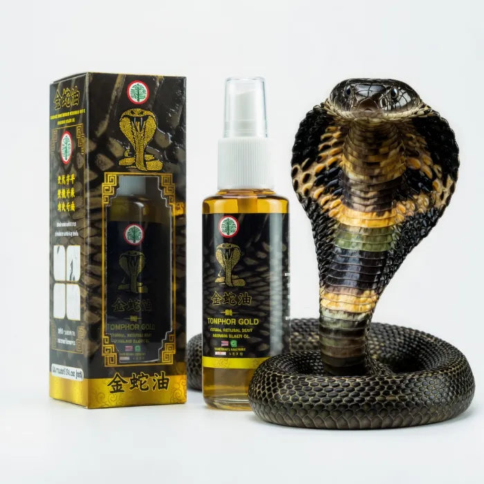 Flacon et boîte Tomphor Gold présentés à côté d’un cobra, huile relaxante utilisée pour apaiser rapidement tensions musculaires et raideurs. Packaging noir et or avec illustration de cobra et indications d’usage.
