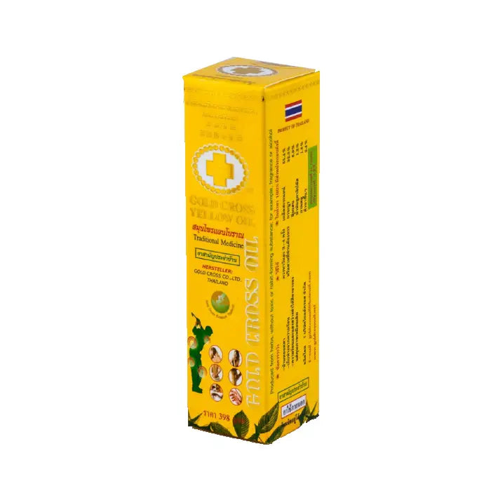 Boîte jaune de Gold Cross Yellow Oil, remède traditionnel thaïlandais. Le packaging montre une croix blanche, des indications d’usage et des illustrations des zones d’application. Produit utilisé pour soulager douleurs musculaires, tensions et piqûres d’insectes.