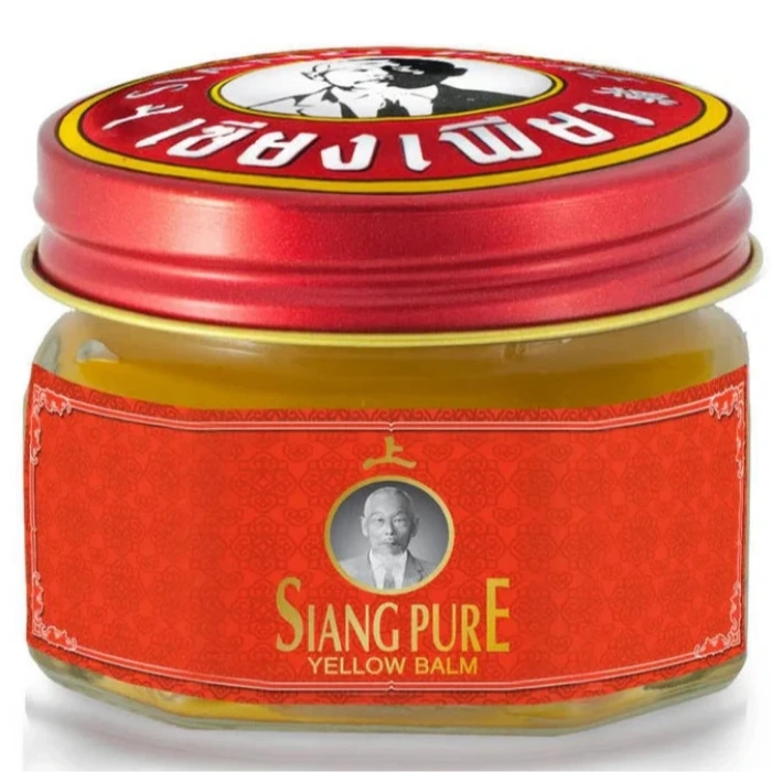 Pot et boîte de baume White Monkey Holding Peach avec un singe tenant une pêche sur l'étiquette. Texte en thaï et en anglais. Utilisé pour soulager les douleurs musculaires.